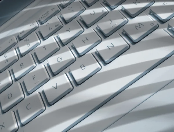 Shadows on laptop keyboard — Stock Photo, Image