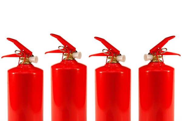 Quatro extintores de incêndio — Fotografia de Stock