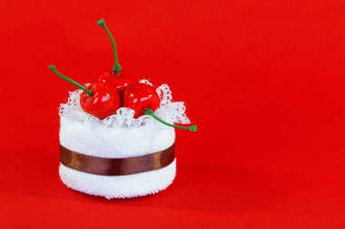 A towel with a cherry on a red background