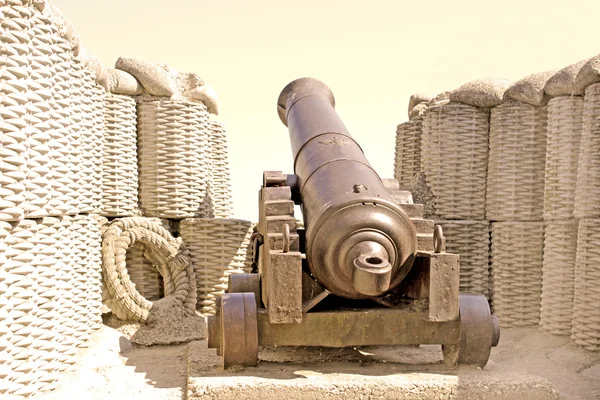 Retro black melal gun in the fortification in sepia — Stock Photo, Image