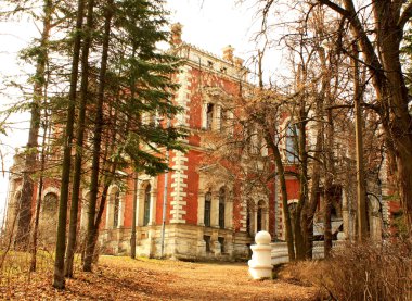 Abandoned old estate among the leafless trees clipart