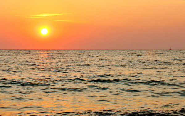 Sun set over the sea horizon