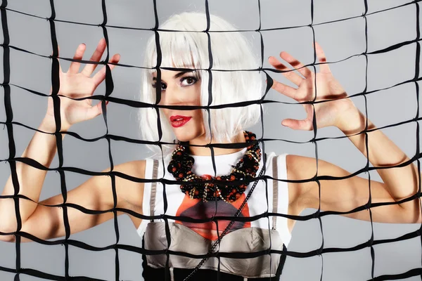 Fashion girl behind a mesh — Stock Photo, Image