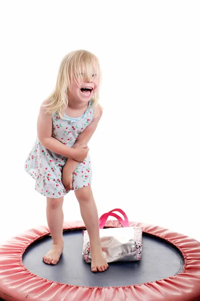 Cute little girl on a trampoline — Stock Photo, Image