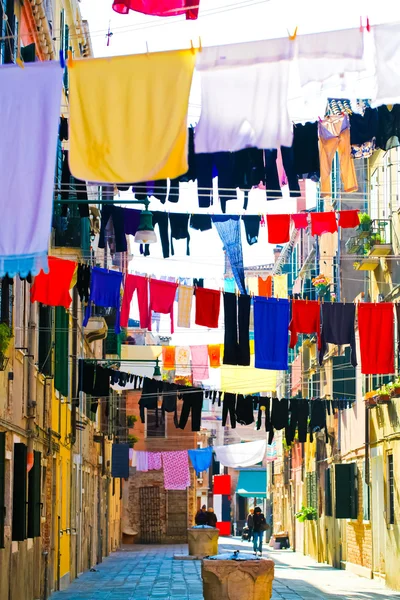 Beautiful venetian street with clothes — Stock Photo, Image
