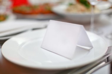 Blank plate and card for guests in restaurant clipart