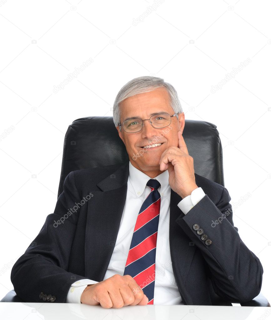 Mature Businessman Seated at Desk
