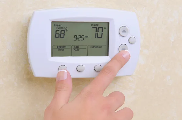 Thermostat setting the temperature Stock Image