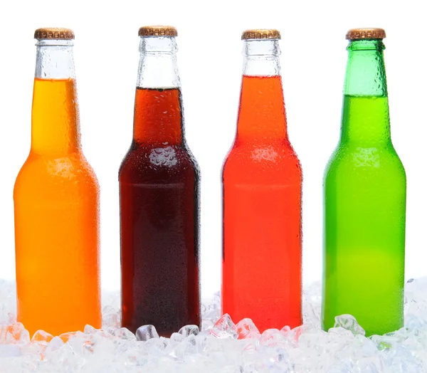 Quatro garrafas de refrigerante no gelo — Fotografia de Stock