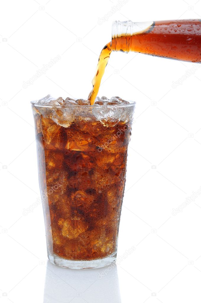 Cola Pouring from Bottle into Glass of Ice