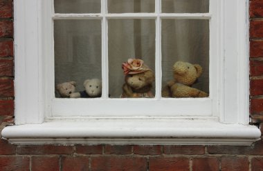 Family of teddy bears on the window. clipart