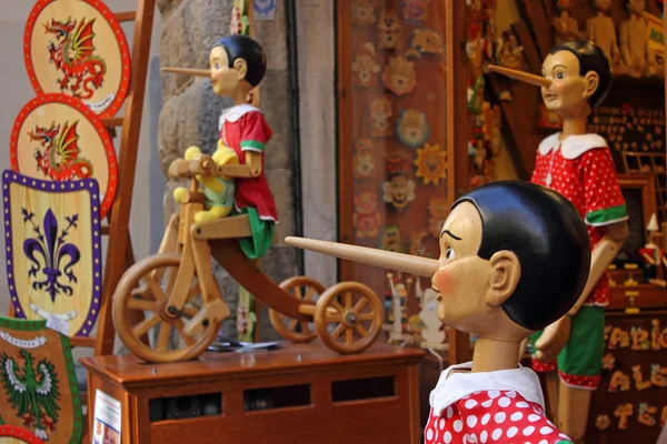 stock image Pinocchio inviting tourists in souvenirs shop