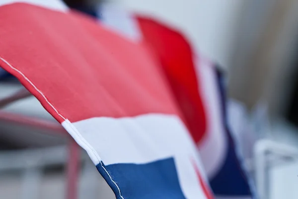 stock image A united kingdom union jack of red, white and blue against a summer sky