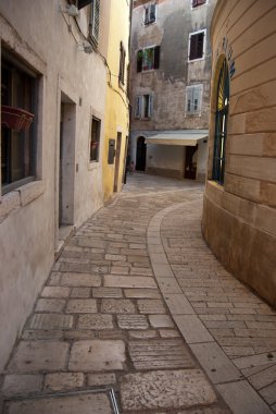 Narrow street in medieval Porech old town clipart