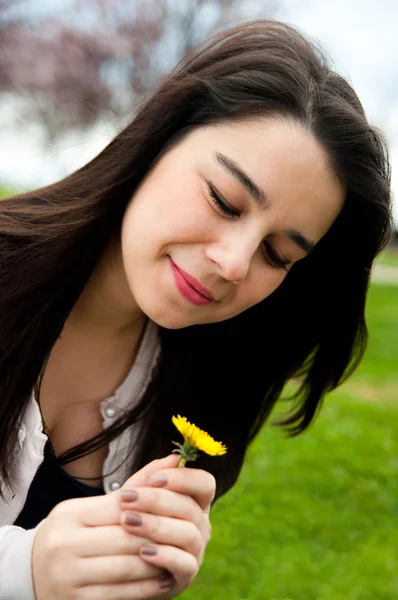 stock image Portrait of a happy beautiful young female holding a flower