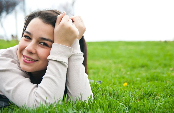 Beautiful young female lying on the grass — Stock Photo, Image