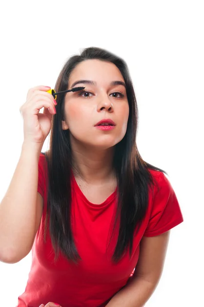 Beautiful young female applying her make up — Stock Photo, Image