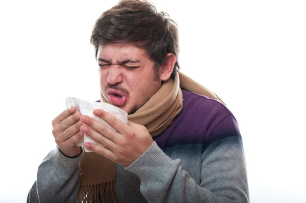 Portrait of a young male sneezing — Stock Photo, Image