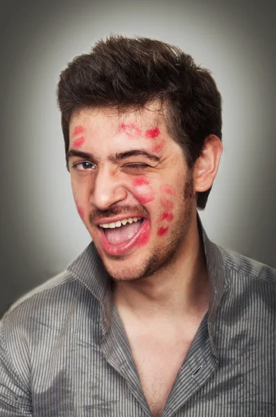 Portrait of a handsome male with a face full of kisses — Stock Photo, Image