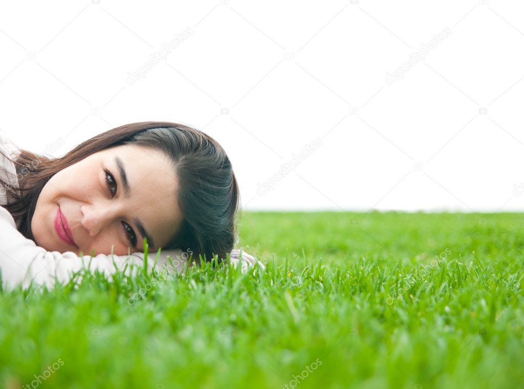 Beautiful young female lying on the grass