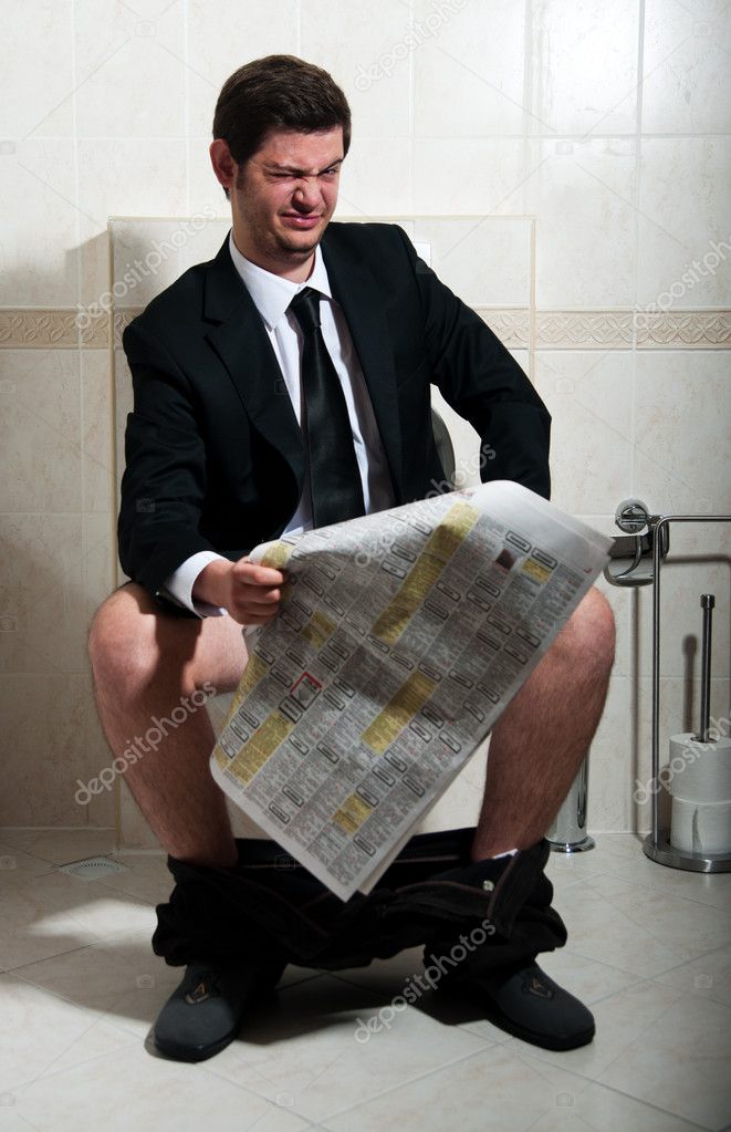 Young businessman at the toilet
