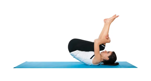 Beautiful young female exercising on a blue matt — Stock Photo, Image