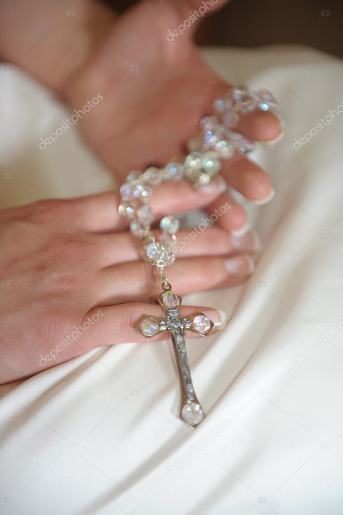 Bride holding a cross necklace