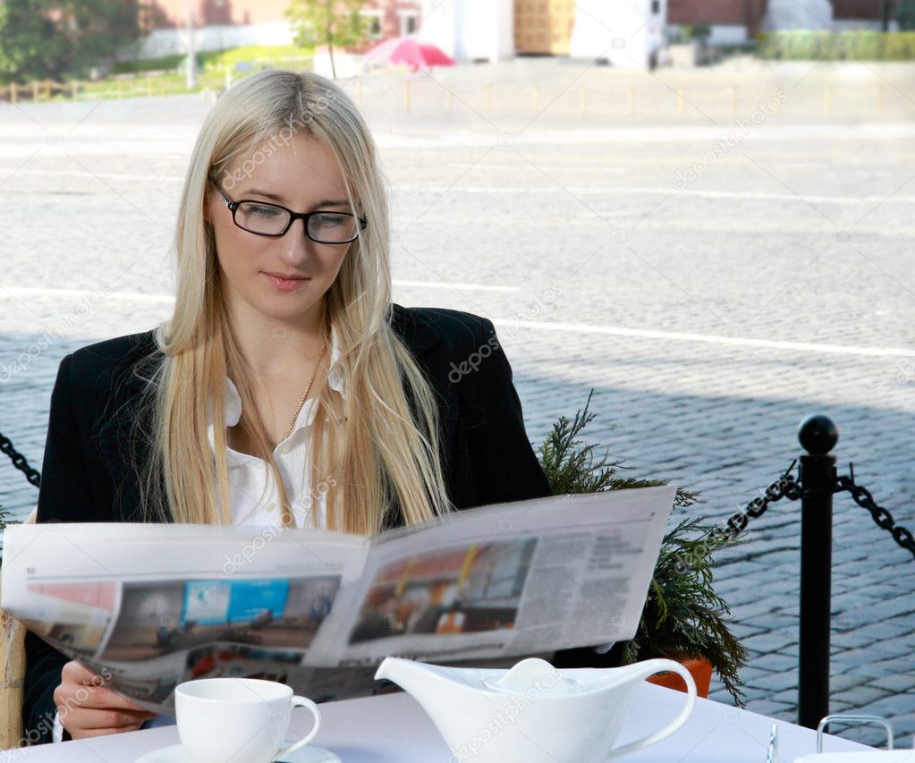 Woman is reading newspaper