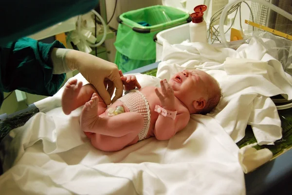 Recém-nascido: primeira limpeza e inspeção na sala de parto — Fotografia de Stock