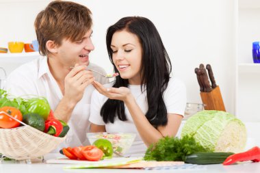 Young couple in kitchen clipart