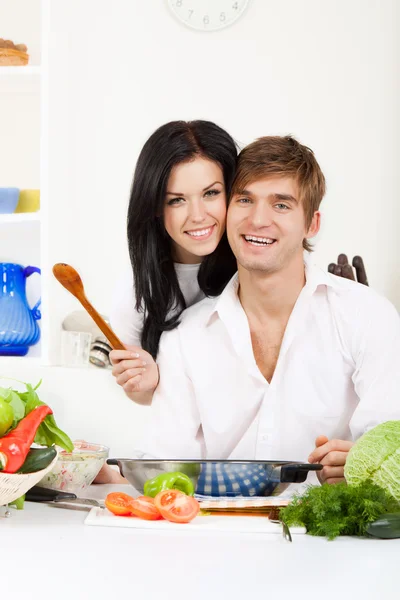 Young couple in kitchen Stock Picture