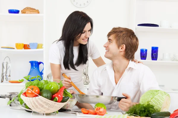 Young couple in kitchen Stock Picture