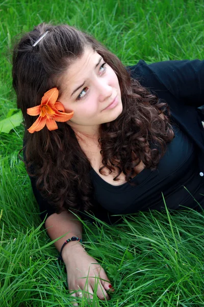 Teenager about a flower — Stock Photo, Image