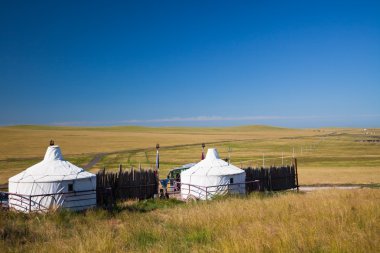 Yurt on the blue sky blackground clipart