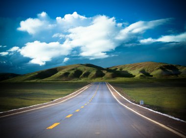 Road to the future with the mountain and blue sky background outdoor.