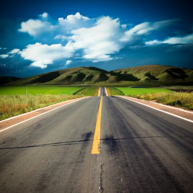 Road to the future with the mountain and blue sky background outdoor.