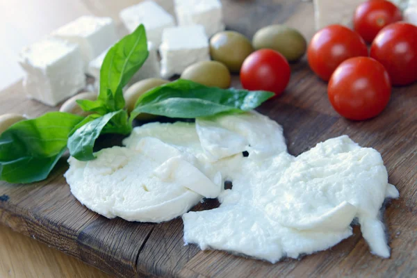 Mozzarella cheese, feta, tomatoes and basil — Stock Photo, Image