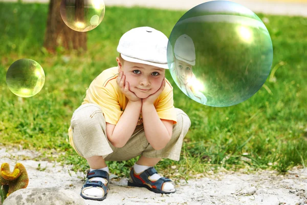 Soap bubble. The boy on a nature — Stock Photo, Image
