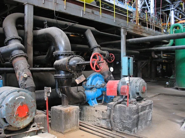 Red valve and electric water pumps at power plant — Stock Photo, Image