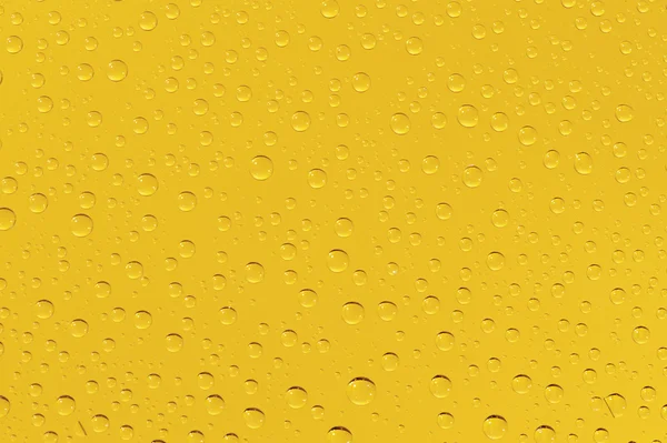 Many water drops on the yellow background — Stock Photo, Image