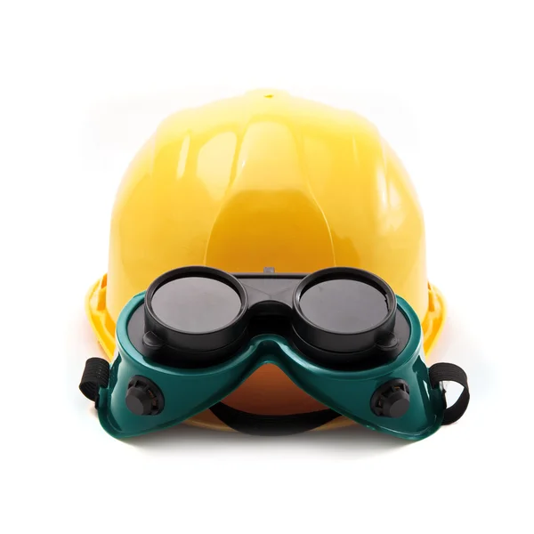 Yellow hard hat and protective goggles — Stock Photo, Image