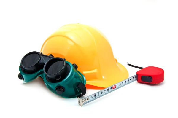 Yellow hard hat and protective goggles — Stock Photo, Image