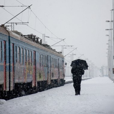 Snowing on a train station clipart