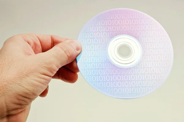 Mão com um disco de DVD — Fotografia de Stock