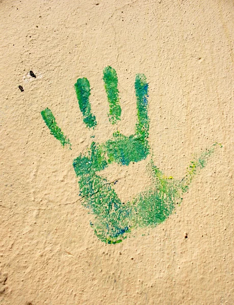 stock image Green handprint on the wall