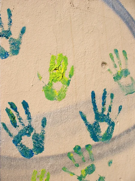 Stock image Green handprints on the wall