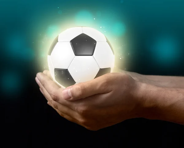 Soccer ball on hand — Stock Photo, Image