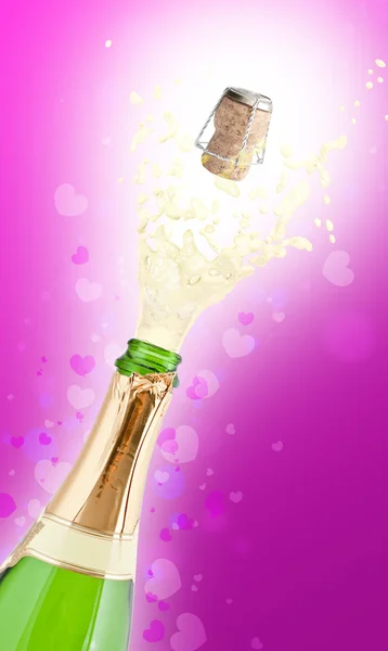 Bottle of champagne popping its cork and splashing — Stock Photo, Image