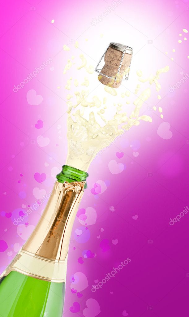 Bottle of champagne popping its cork and splashing