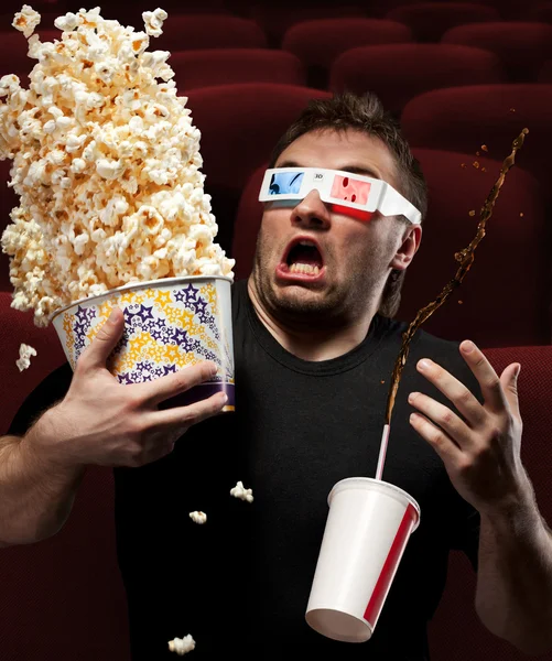 Very scared man watching 3D movie — Stock Photo, Image